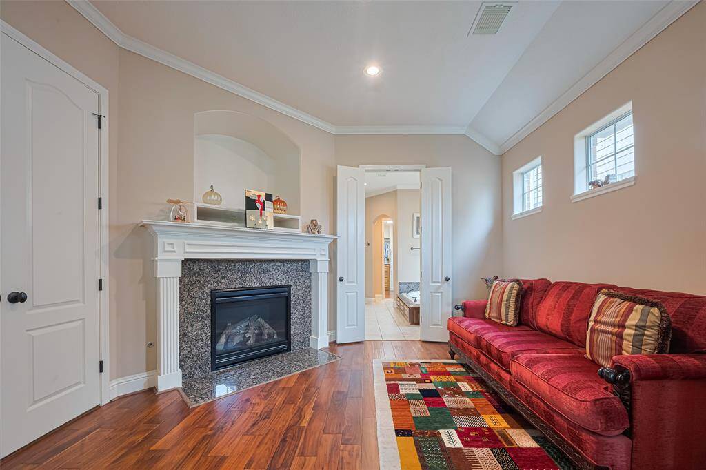 The space is anchored by a classic fireplace with built-in shelving and arched architectural details that add a touch of elegance