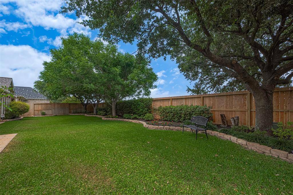 Whether enjoying a peaceful morning coffee or hosting an outdoor gathering, this backyard provides serenity and space