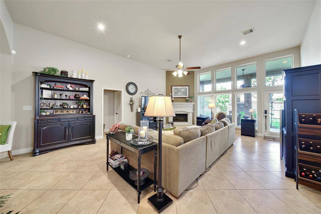 Floor to ceiling windows create a luminous space with a beautiful view of the backyard oasis.