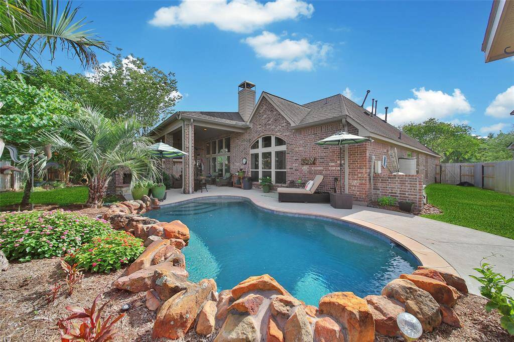 Enjoy the beautiful sparking pool oasis with expertly designed landscaping.