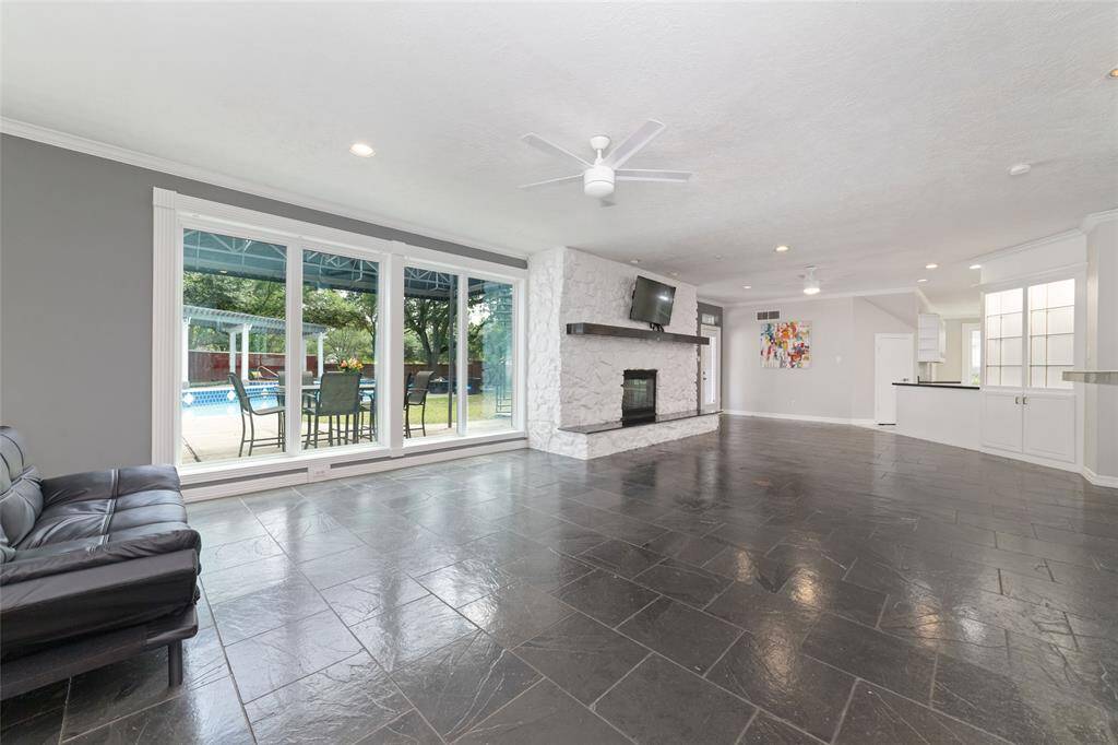 Enjoy a large living area with a great view of the beautiful back yard.  Includes a fireplace and the TV and mount stay with the home.  (All of the windows in the house have been replaced with double pane windows and come with a warranty).