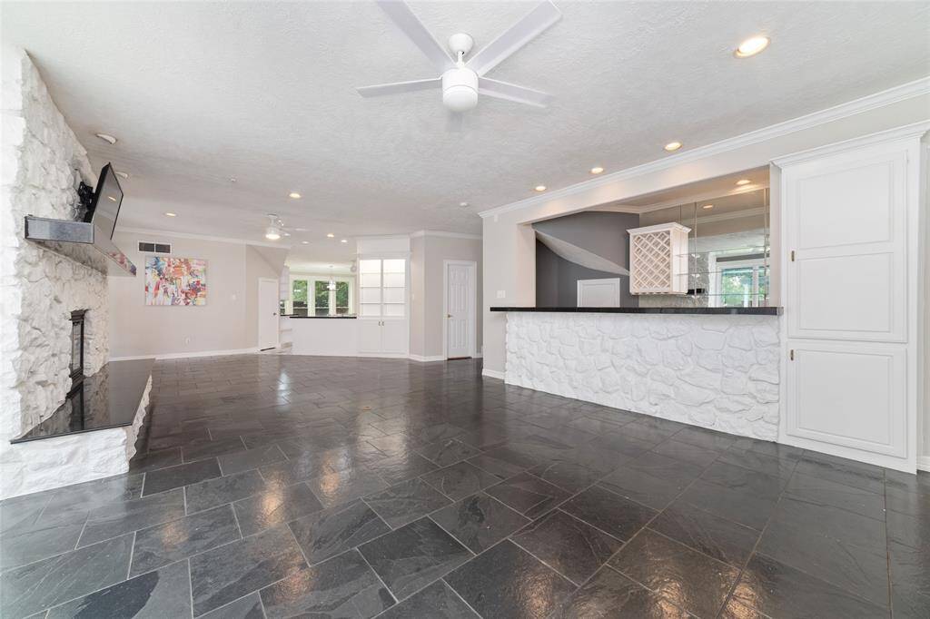 Another view of the living area and the wet bar (includes mini refrigerator, drink refrigerator and ice machine with lots of storage and a closet)