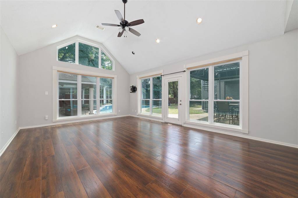 A large primary suite on the first floor with wood floors, access to the back yard and a great view.