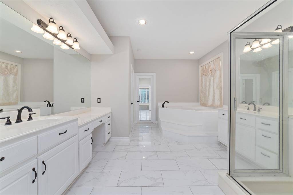 Enjoy a large primary suite with dual large vanities (including a vanity to get ready), a soaking tub and large standing shower, a great spa like retreat.