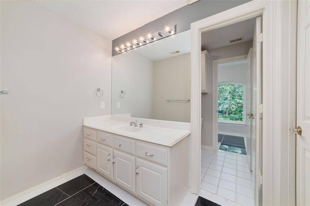 Shared bathroom with beautifully upgraded tile inserts.  (in all of the upstairs bathrooms)