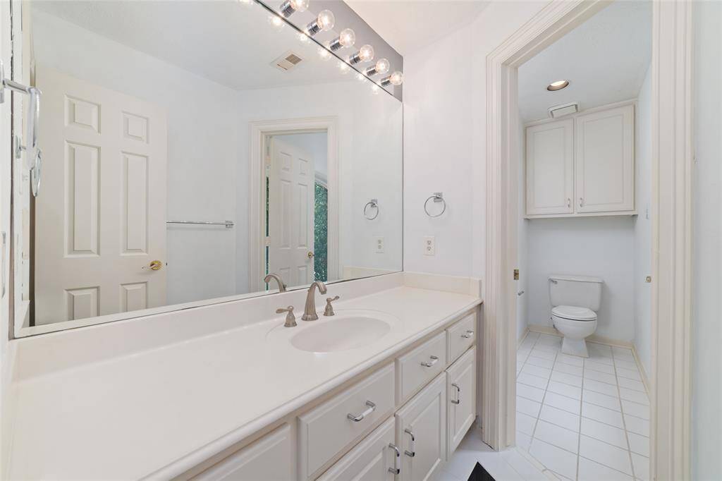 A large shared bathroom upstairs with the upgraded tile inserts.