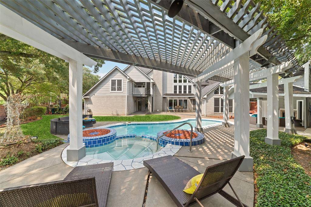 A view from the hot tub and the deck chairs under the pergola.  The chairs and outdoor furniture are staying.  (The cushions/pillow are staging)