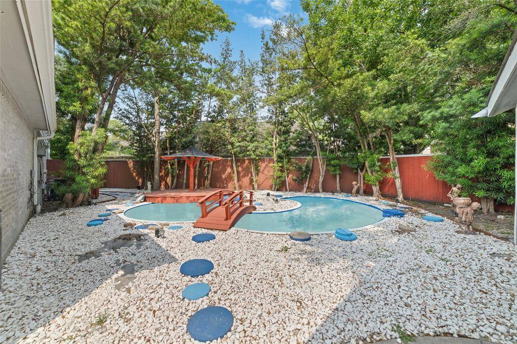 A view of the koi pond on the side of the house.  This is virtually filled with water as it sits empty.