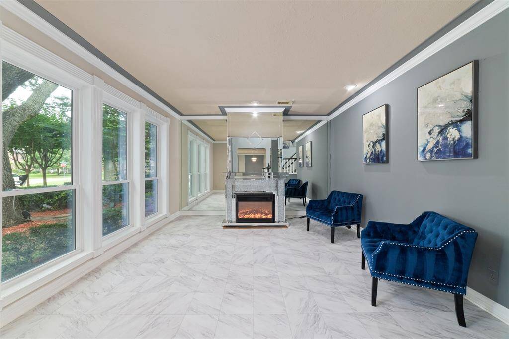 And a beautiful living area with an electric fireplace off of the entrance.