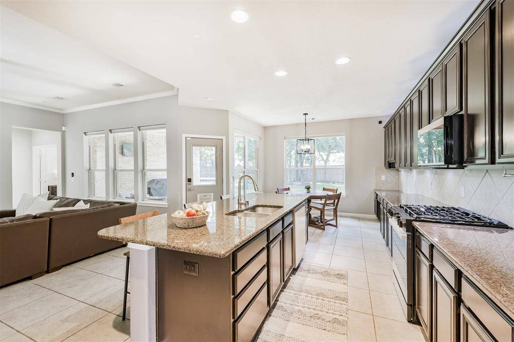 Standing by the refrigerator looking towards to breakfast room and the door leading to the backyard.