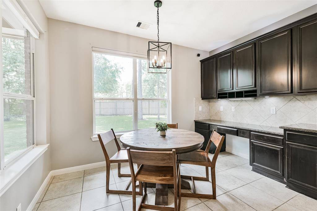 The breakfast room is generously sized to fit your large breakfast table. Don't miss that built-in desk area to the right.