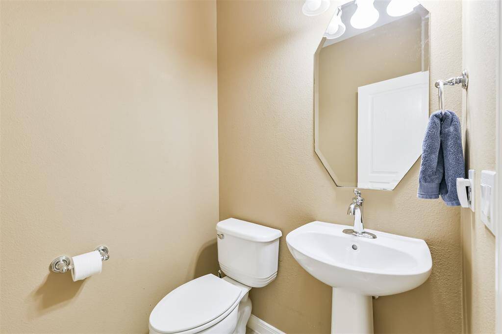 A quick peek into the half-bath that is across the stairway.