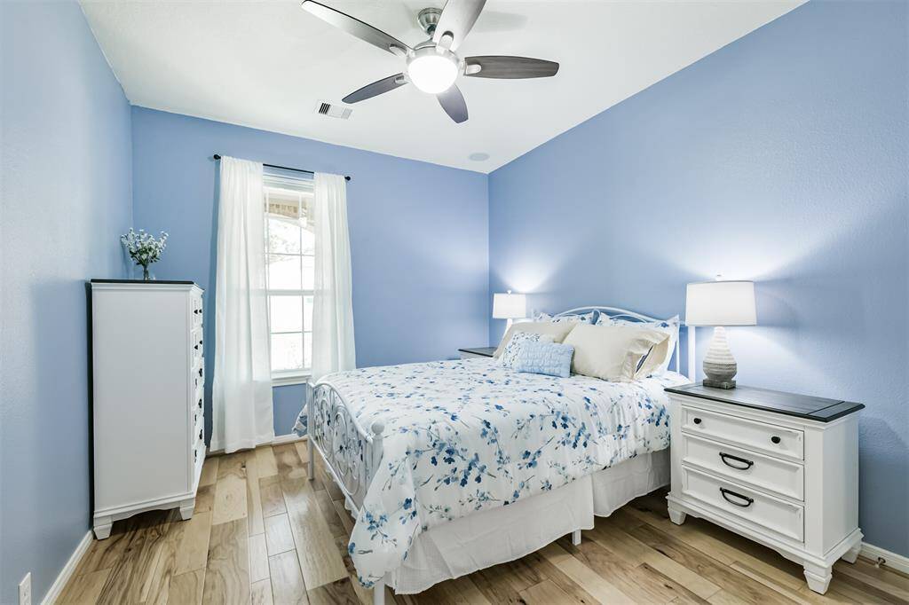 Let's check out the secondary bedrooms. In each you will find the same beautiful flooring found in the office space and primary suite.