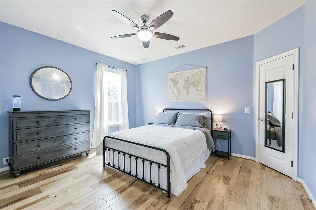 Another spacious bedroom with the natural light filling the space.