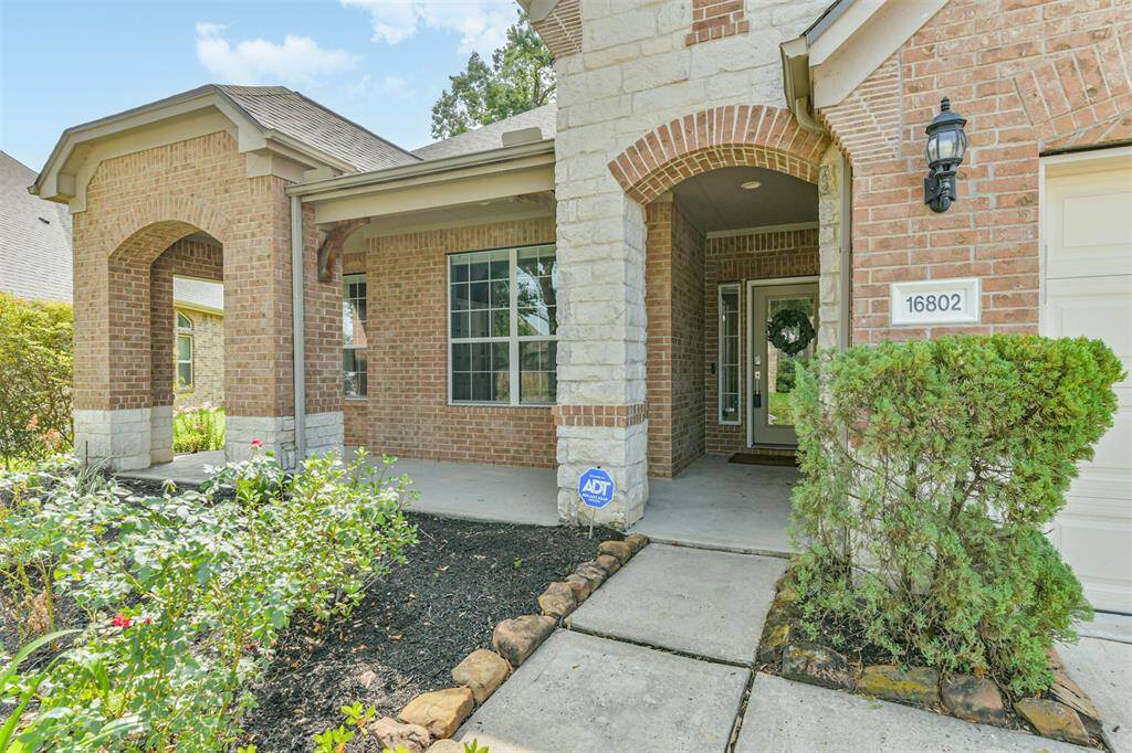 The front landscape is meticulously maintained. Enjoy the cool of the shade on your covered front porch.