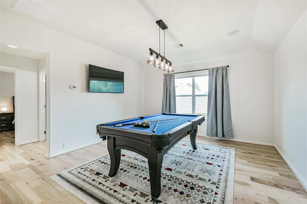 Let's head upstairs to check out the game room and final bedroom.