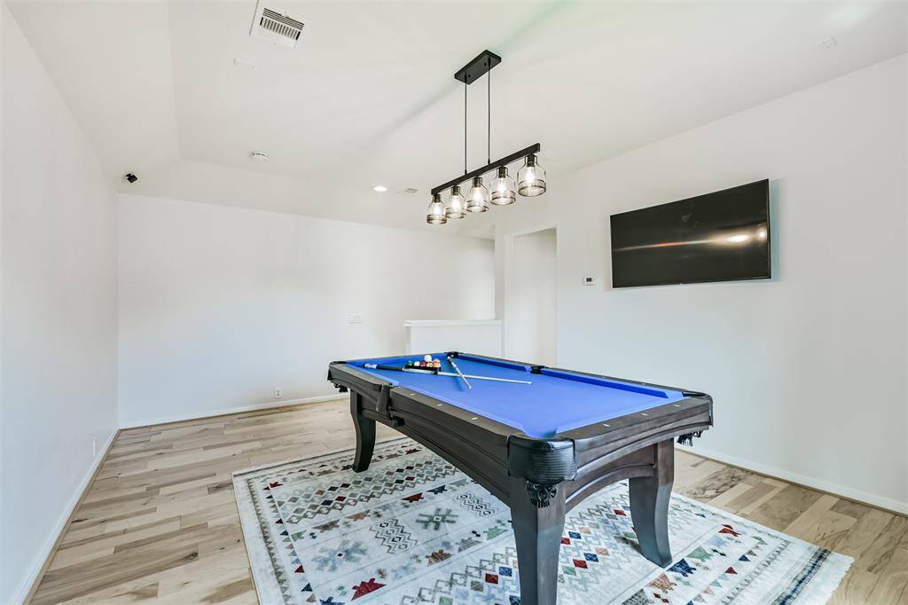 Upon walking up the stairs you come into the game room; large enough for your pool table!