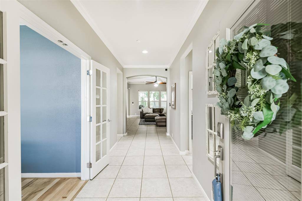 The formal entry welcomes you into the light and bright space. To the left you see the french doors leading to the office.