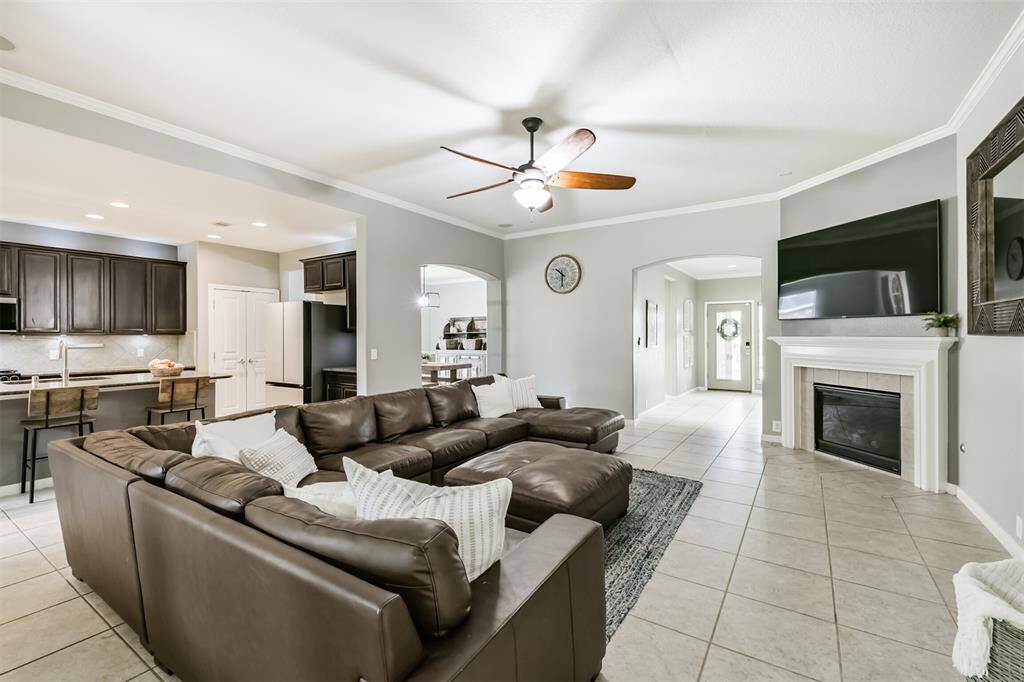 This alternate view shows you the front entryway and the gas log fireplace that anchors the room. To the left is the kitchen that is open to the living room.