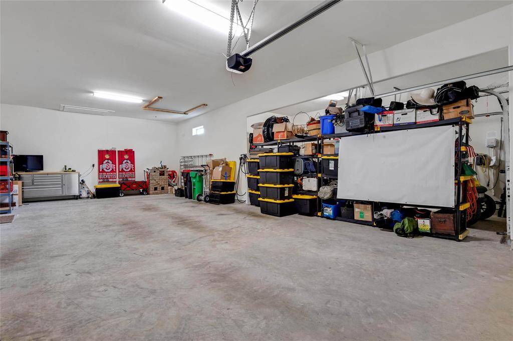 5 car garage with electric car outlet/plug in.  one side is two cars wide and two deep and there is yet another bay with it's own door , perfect for that golf cart. Which is also for sale.