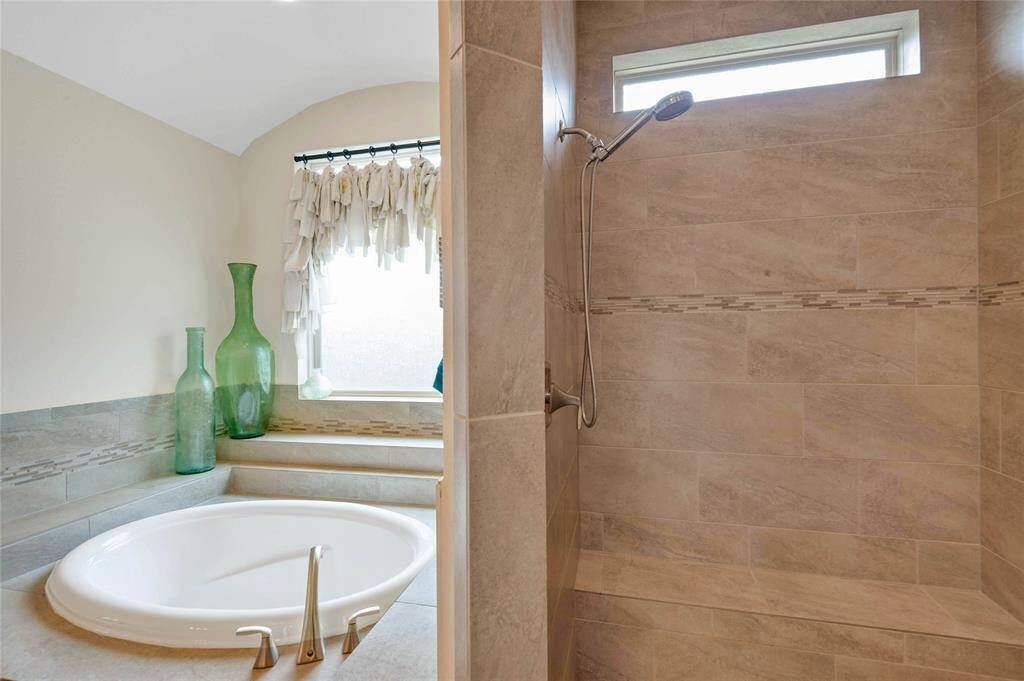 Walk in tile shower rounds out the primary bath with plenty of space and two shower heads.