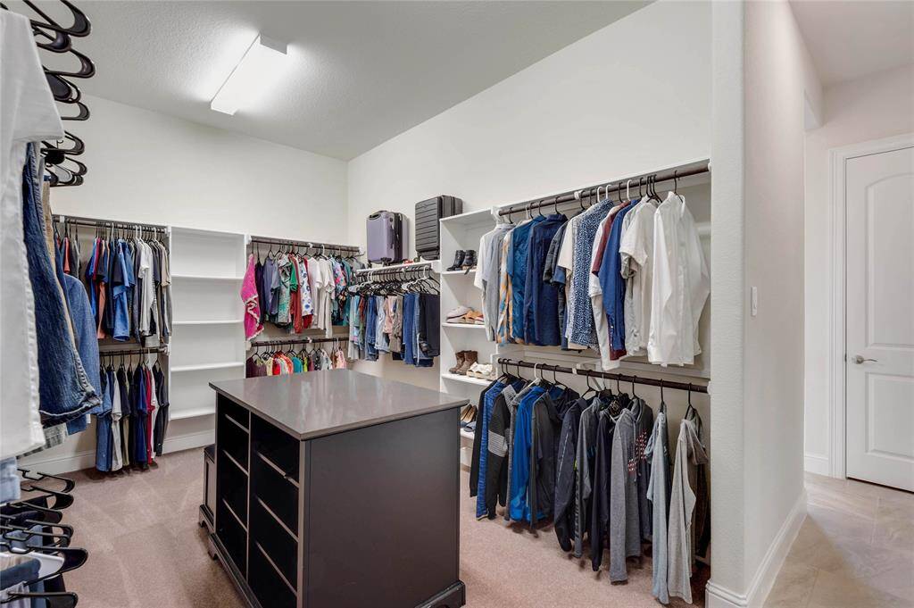 What a dream of a closet!  No lack of space in this primary closet that is linked to the laundry room.