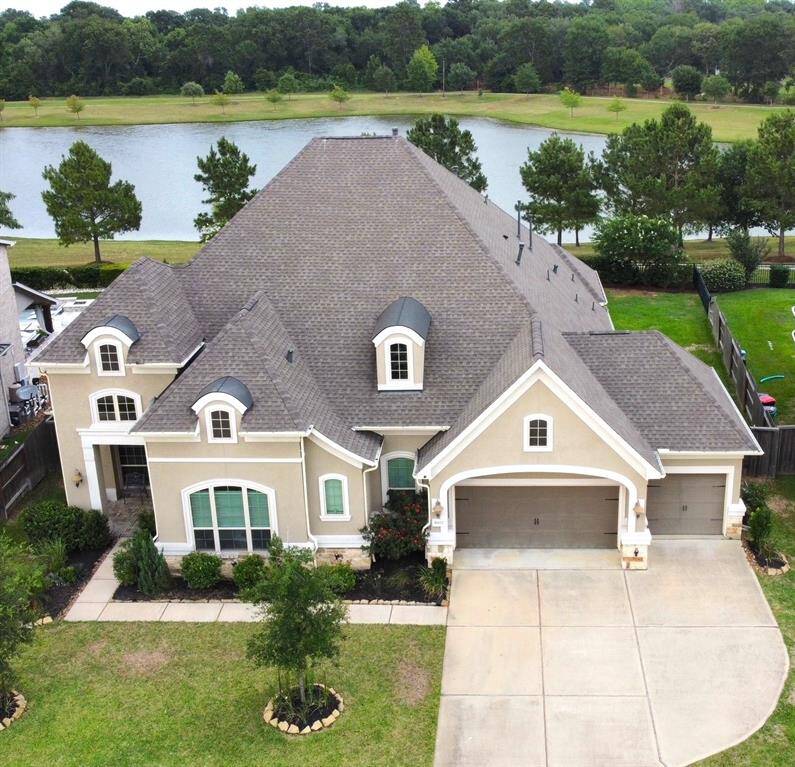 Drone shot of the lot including the lake in the backyard.