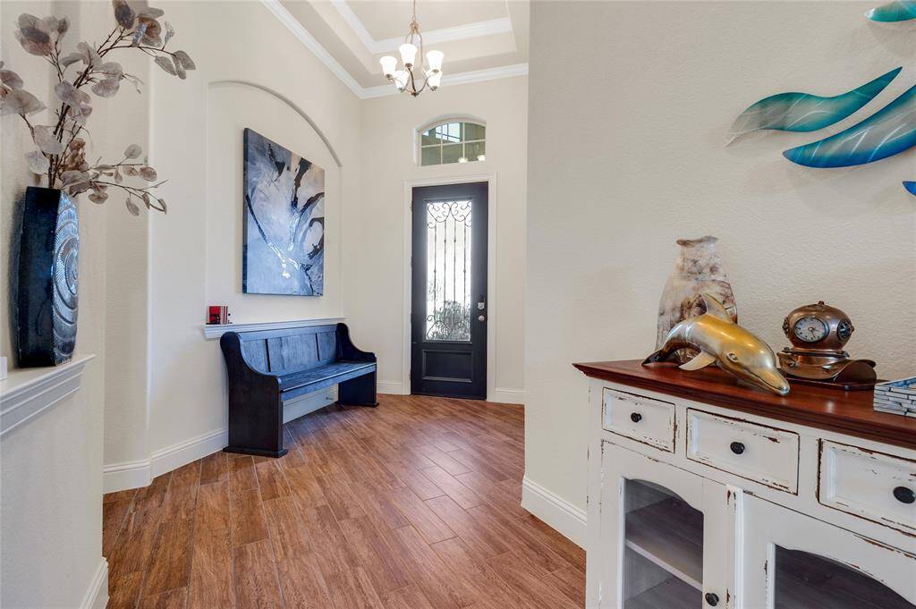 What an enchanting entryway that is not only spacious but light and bright and you will find this durable wood look tile flooring in most of the home.
