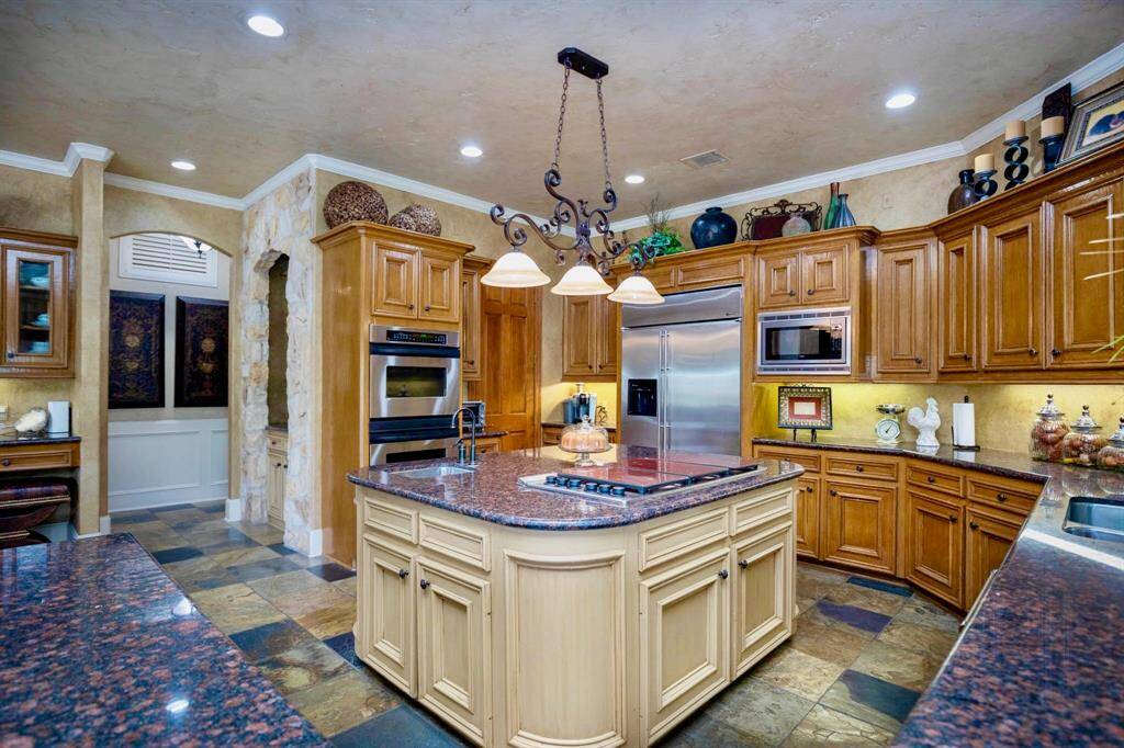 THE KITCHEN IS ENHANCED WITH STAINLESS APPLIANCES INCLUDING DOUBLE OVENS AND GAS COOKTOP!