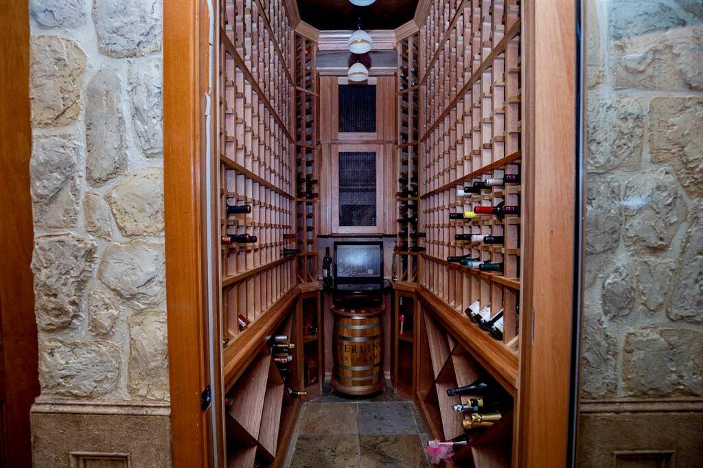THIS HOME FEATURES A CLIMATIZED WINE CELLAR!