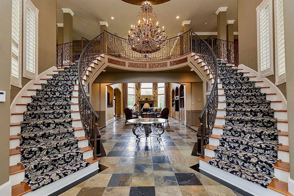 AS YOU ENTER INTO THIS SHOWPIECE, YOU ARE WELCOMED BY THE MAGNIFICENT GRAND DOUBLE STAIRWAY!!!! THIS IMPRESSIVE ENTRY WILL TAKE YOUR BREATH AWAY!