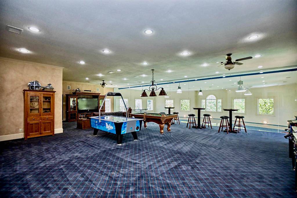 THE SECOND-STORY GAME ROOM IS MASSIVE AND HAS A WALL OF GLASS OVERLOOKING THE GYMNASIUM!