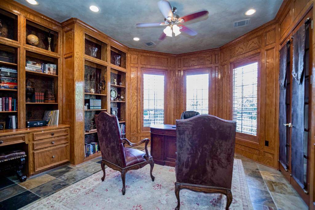 ACCESS YOUR STATELY OFFICE THROUGH FRENCH DOORS AND ENJOY THE RICH PANELED WALLS AND EXTENSIVE BUILT-INS!