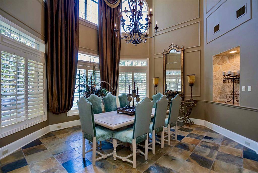 ANOTHER VIEW OF THIS SPACIOUS FORMAL DINING ROOM DISPLAYS THE TWO-STORY WINDOWS WHICH ALLOW FOR BEAUTIFUL NATURAL LIGHT AND VIEWS OF THE MAJESTIC GROUNDS!!!