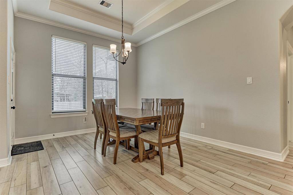 Spacious dining room with a tray ceiling.