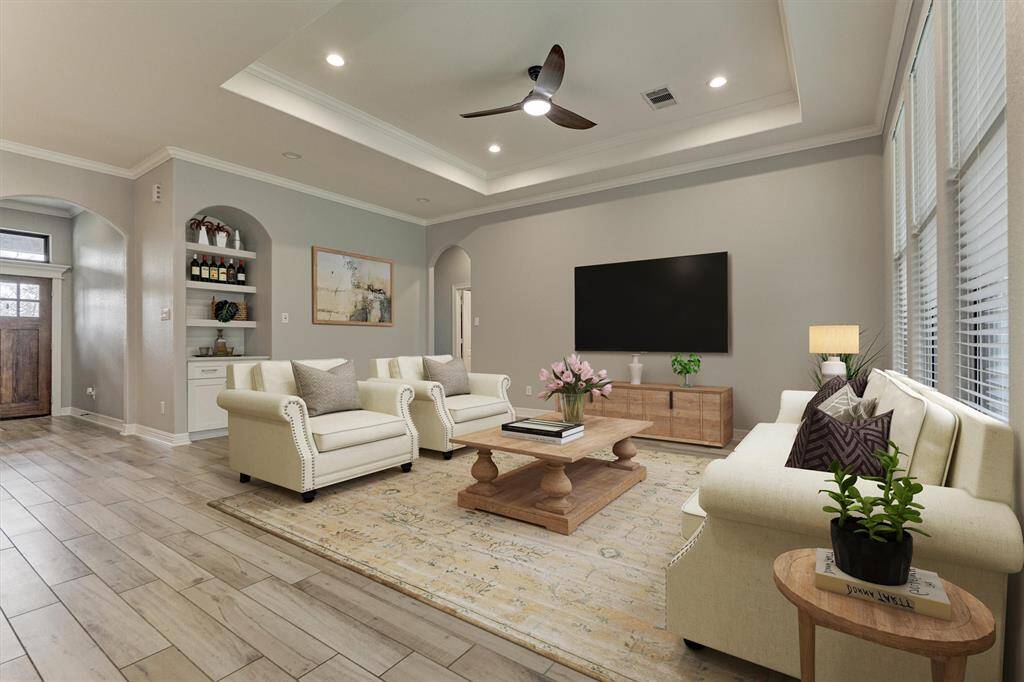 The great room boasts an abundance of space including a dry bar or niche for decorative pieces. *This photo is virtually staged.*