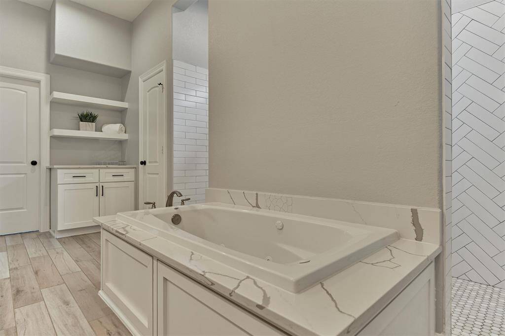 The ultimate source for rest and relaxation! Note the floating shelves and countertop/cabinet space for linens & more.
