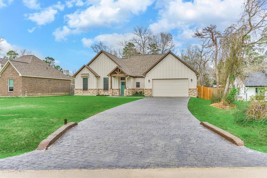 Eye-popping curb appeal with stylish Board-n-Batten siding, brick wainscoting, and stamped concrete double-wide driveway!