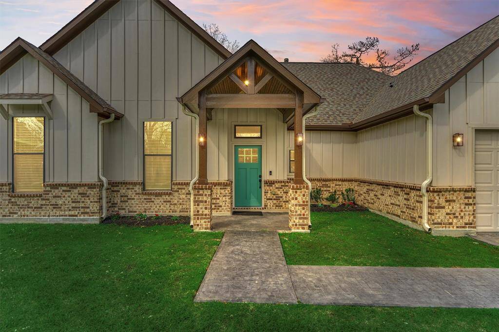 Handsome truss-encased front porch entry with brick wainscoting - this home is ready for immediate move-in!