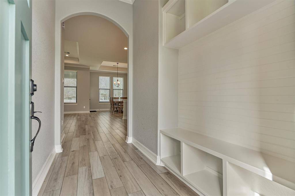 Upon entry, you're greeted with fresh interior paint and continuous "wood tile" flooring flowing throughout the main living area!