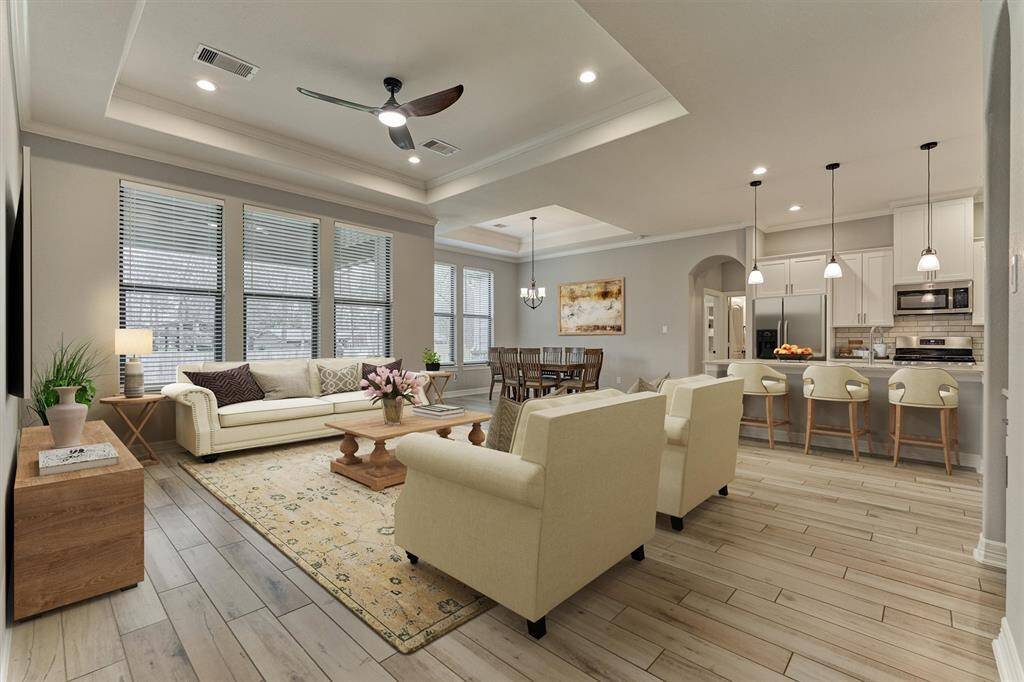 So much space and natural light in the great room with expansive views overlooking an oversized, vaulted covered patio & huge yard! Note the pop-up ceiling for added architectural flare. *This photo is virtually staged.*