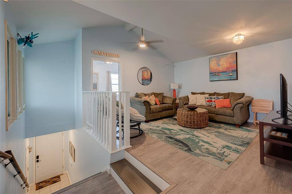 Captured from the top of the stairs, this image highlights the welcoming entryway leading up to the heart of the home—a comfortable, open-concept living space.