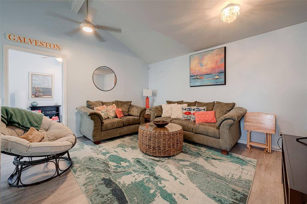 A cozy yet airy space with durable vinyl plank flooring, a ceiling fan for added comfort, and an adjacent bedroom just steps away.