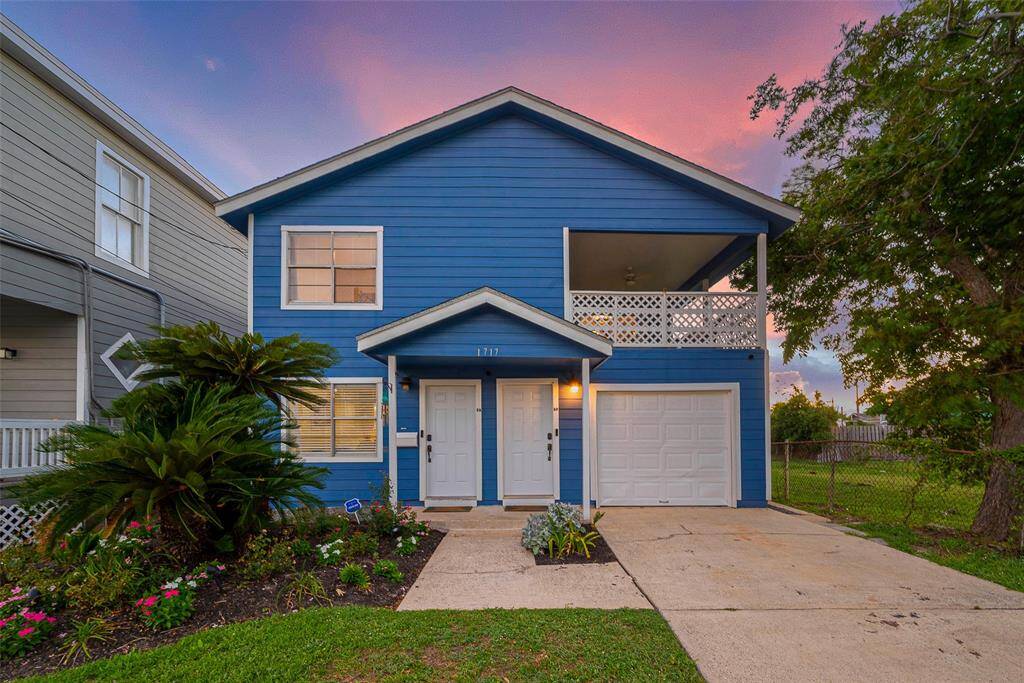As the evening sets in, the bright blue and white exterior glows warmly under the soft twilight, accentuating the home’s inviting curb appeal. A well-kept front lawn and neat facade complete the picture.