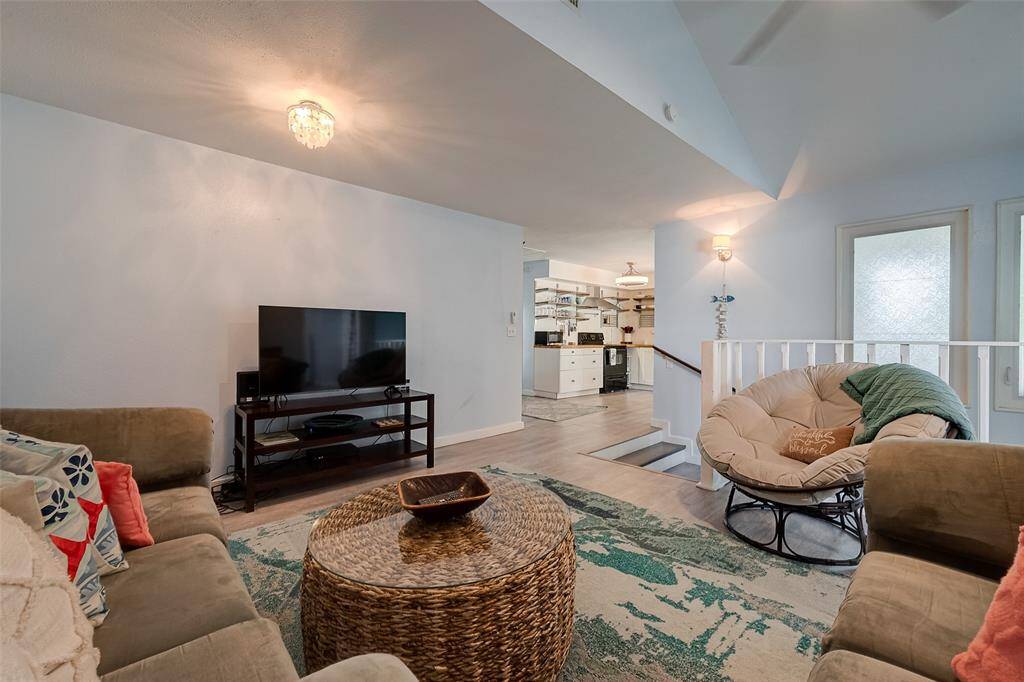 Slanted ceilings enhance the sense of space in this living area. Across the room, the kitchen remains in view, making for easy entertaining and daily living.