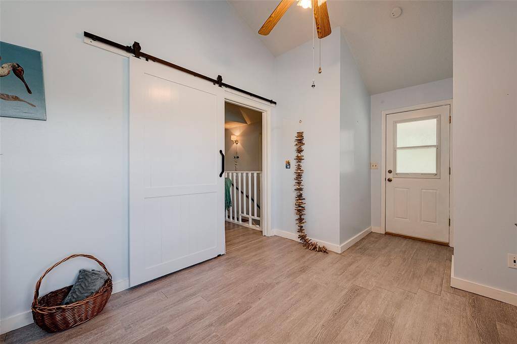 A stylish barn door adds character to this room, while a glass paneled door leads directly to the private balcony—an added bonus for those who enjoy fresh air and outdoor relaxation.