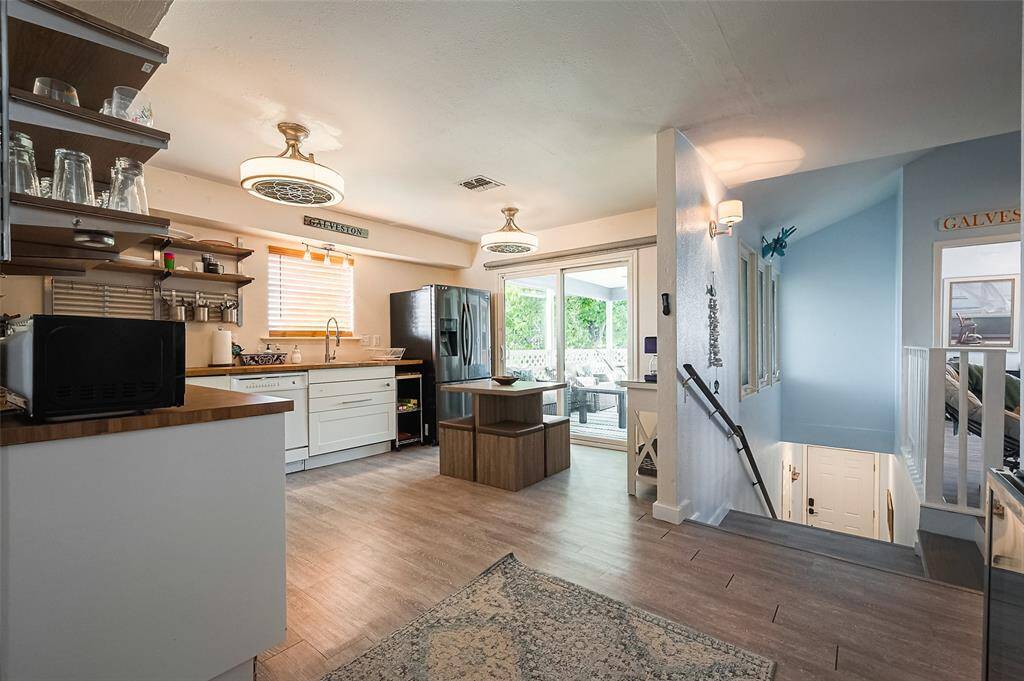 An open layout allows for effortless connection to the living area across the stairway landing, making conversations and hosting seamless.