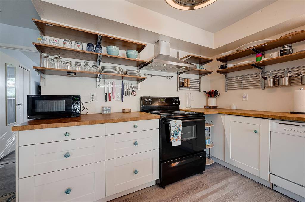 Overhead shelving, lower cabinets, and a tucked-away under-counter storage area maximize space while keeping everything within easy reach.