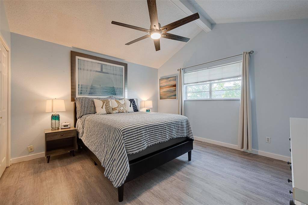 Spacious and bright, this bedroom is filled with natural light from a large window. A stylish ceiling fan adds comfort, making it a refreshing and relaxing space.
