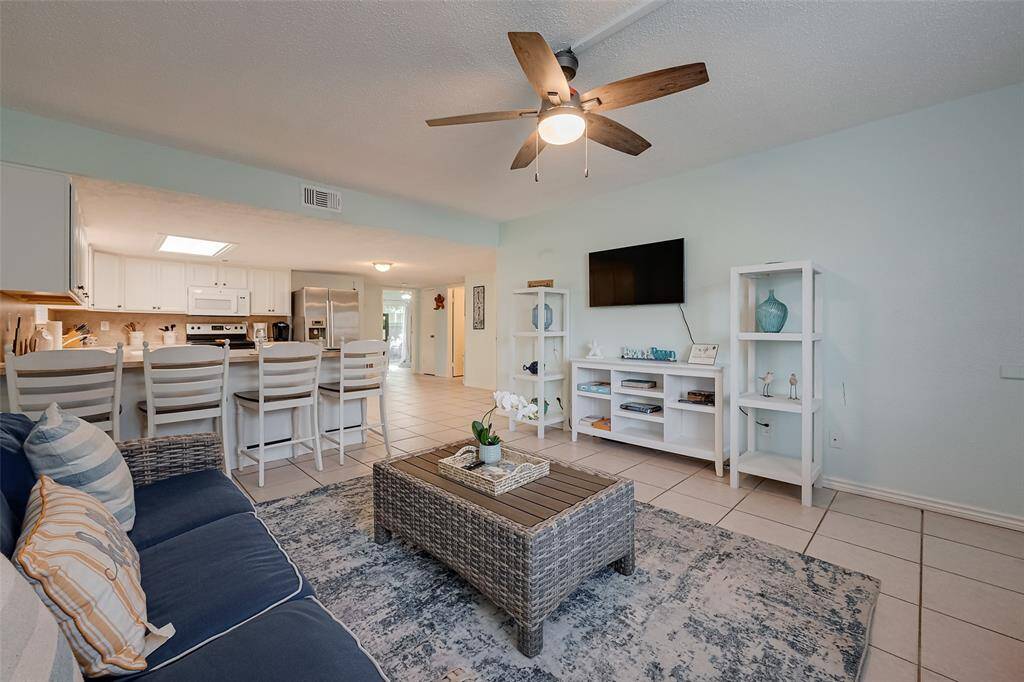 Flowing seamlessly into the open kitchen, the breakfast bar offers additional seating, making it a perfect spot for casual dining.